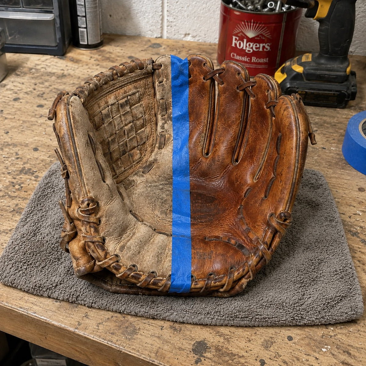Half-done before and after on a dried-out old baseball glove, blue tape down the middle