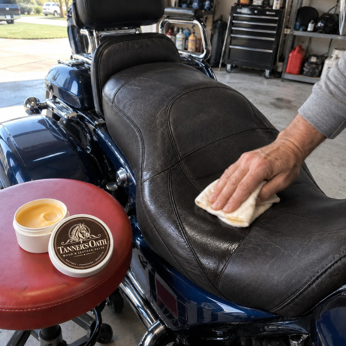 Rubbing Tanner's Oath into a leather motorcycle seat with a cloth