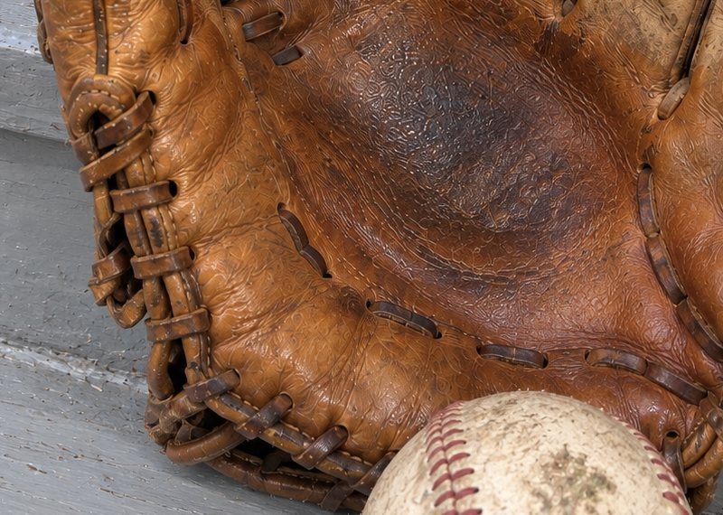 The heel lacing of a conditioned glove, a ball resting against it