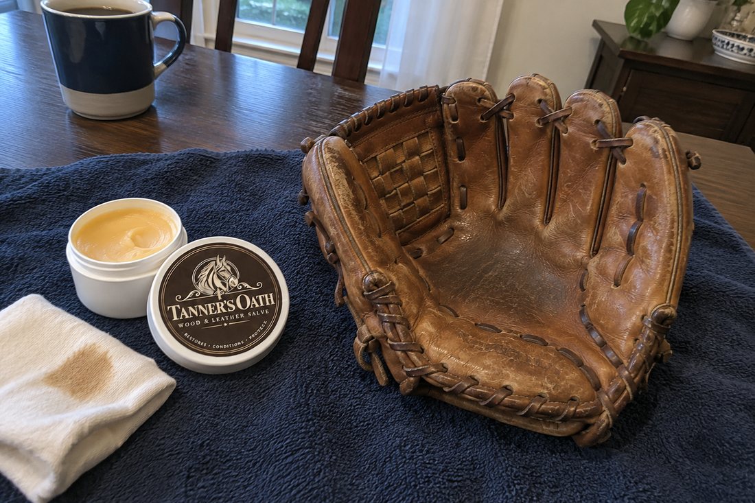 The coated glove resting on a towel with the open jar beside it