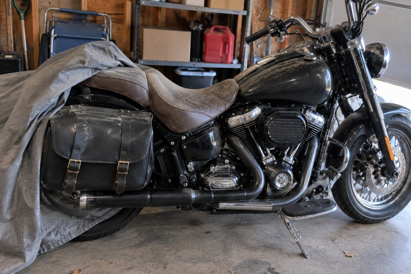 Dad's bike as found in the garage: dust cover half pulled back, the leather seat faded and thirsty