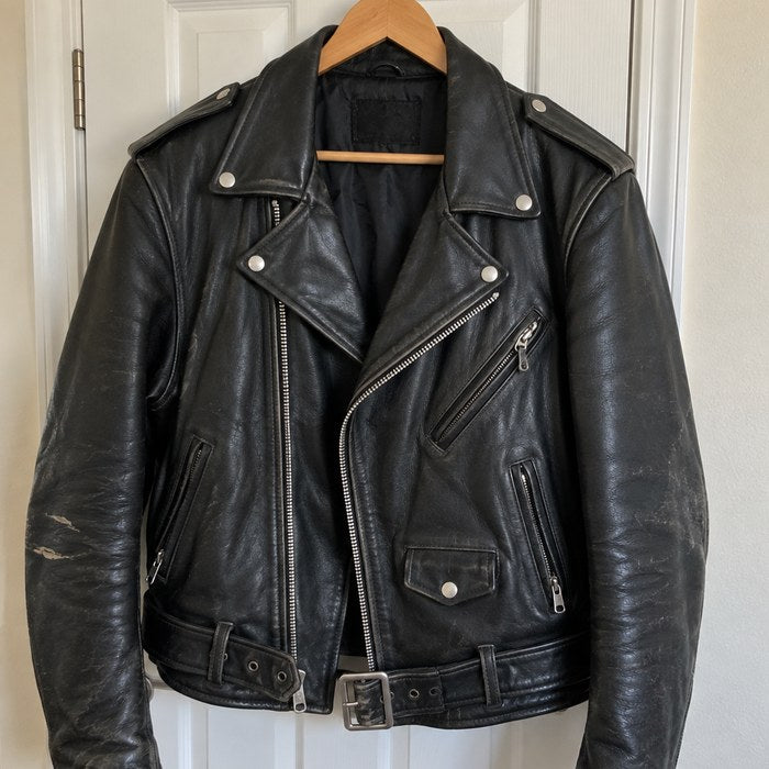 Black leather riding jacket on a hanger